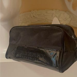 Burberry patent and covers toiletry bag. large inside fits into a lot of stuff